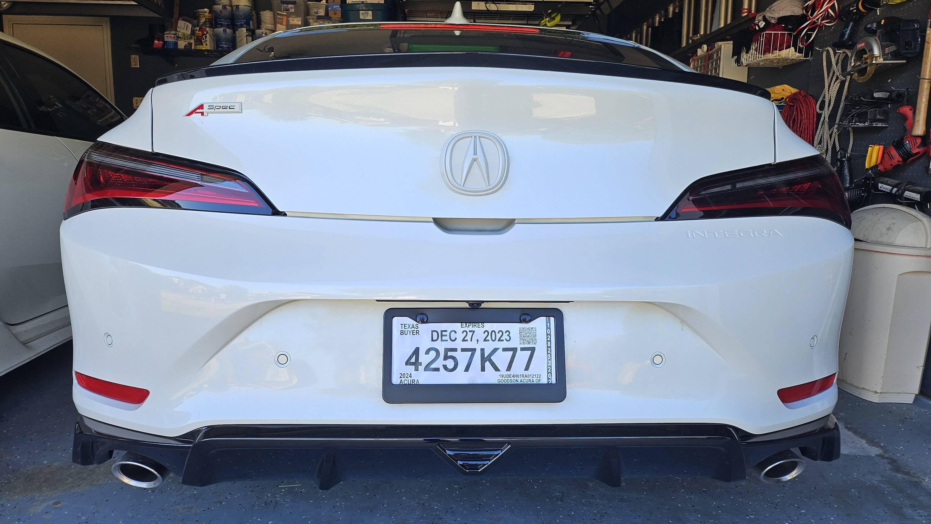 Acura Integra Rear black emblem install with white background. Integra